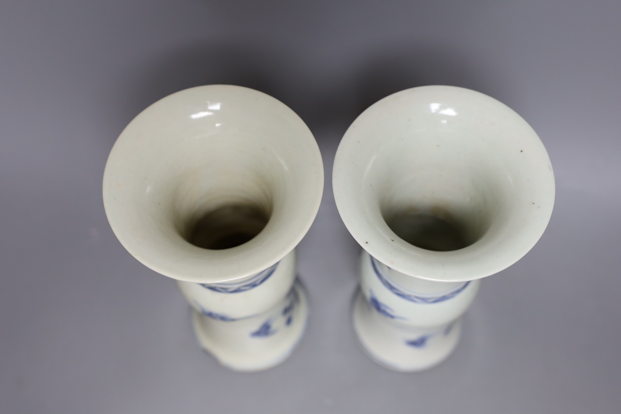 A pair of 19th century Chinese blue and white beaker vases, 23.5cm